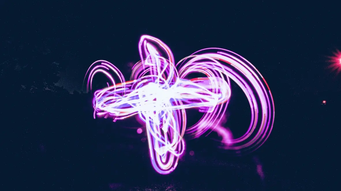Experimental photograph with psychedelic, colorful shapes in a field outdoors at night.