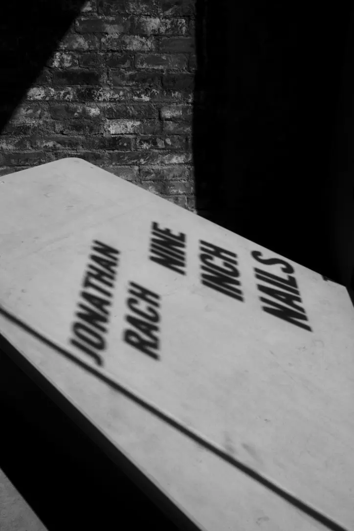 A shadow projected by the window signage for a Jonathan Rach photography show at Behind the Gallery.